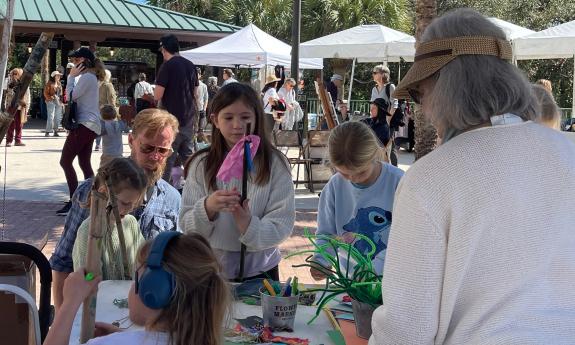 Children learning crafts at the kids zone at the Lullaby of the Rivers Festival