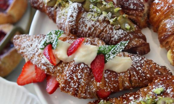 Assorted croissants with toppings and powdered sugar