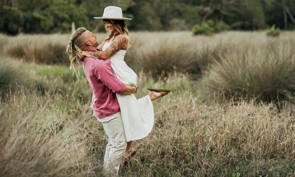 An engaged couple in a field