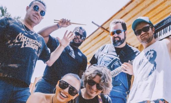 Moonstone Riders band standing together, outside, smiling
