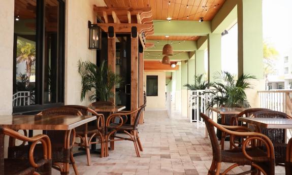 Tables and chairs taking up the outdoor patio area