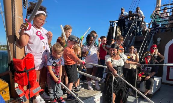 The young crew of the pirate ship prepares to fight the bad pirates