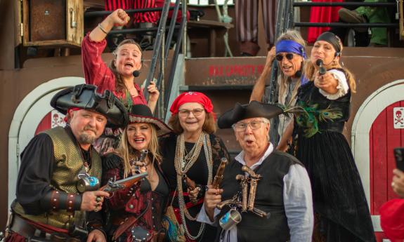 The pirate crew posing with weapons and scary faces