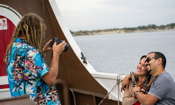 A couple on the Tropical Cruise pose for a sunset portrait
