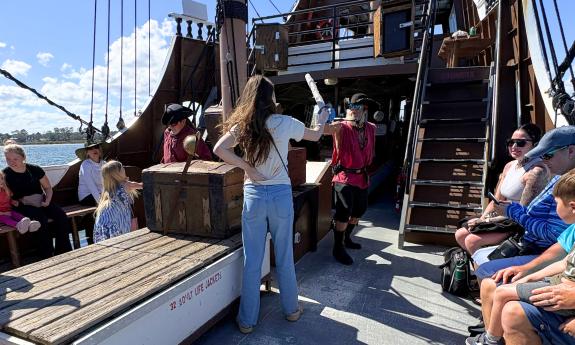 A young guest learns to swordfight abord St. Augustine's pirate ship