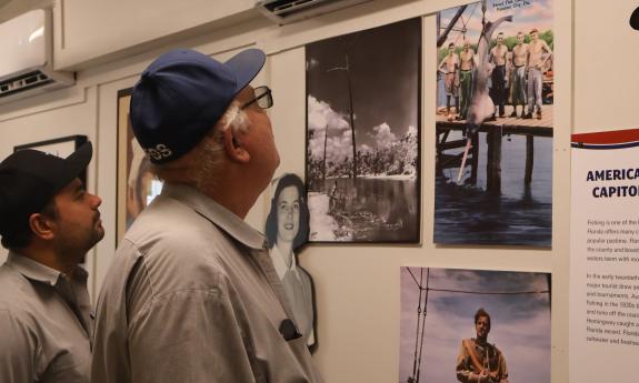 Two gentlemen viewing exhibits in the Florida Freedom Truck