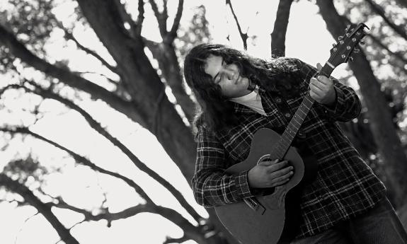 Musician Lane Drix in the winter under stark trees