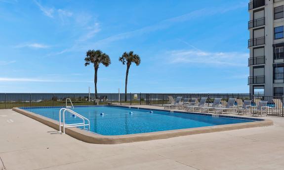 An outdoor pool overlooking the beach