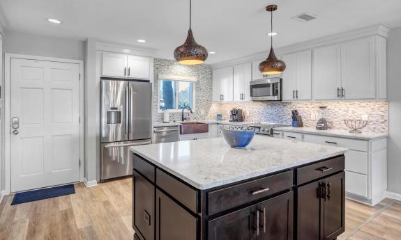 The kitchen area with an island feature in the middle