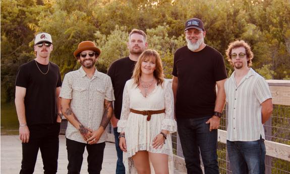 Andria Shinn and The Loyal Souls standing together, on a dock.