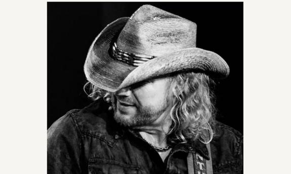 Songwriter Anthony Smith in cowboy hat, on stage