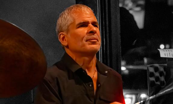 Chris Hadjopoulos of House Cats band, playing drums