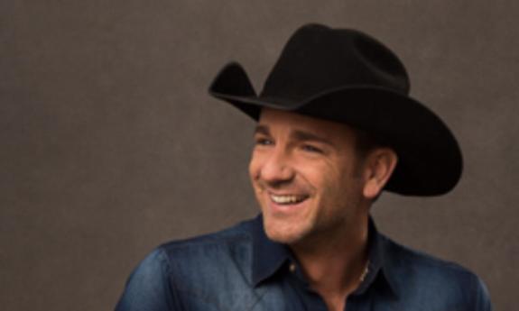 Songwriter Craig Campbell in black cowboy hat, smiling