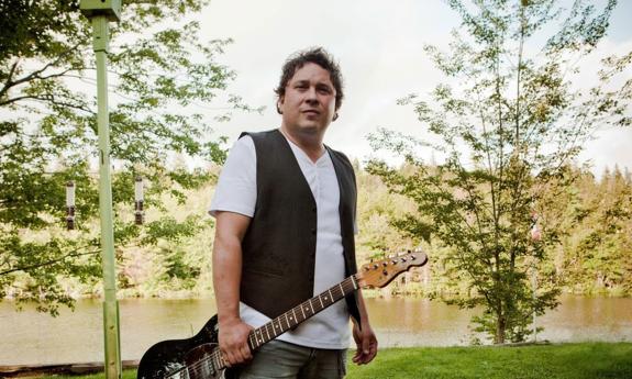 songwriter Gordie Sampson standing outside with guitar