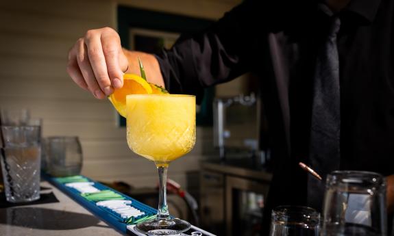 The bartender on the deck bar, finishing a drink