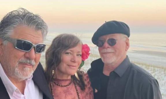 Rusty Springfield standing at the beach with the duo Buffalo Rose