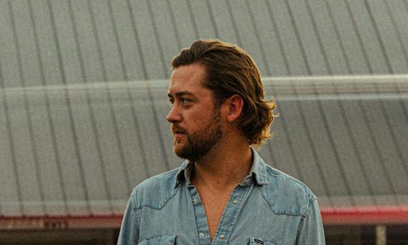 Side view of songwriter Sam Banks, outside
