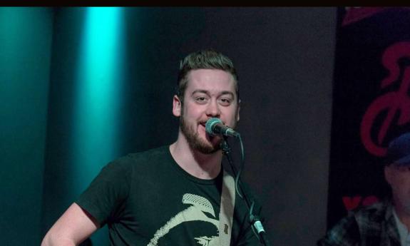 Songwriter Sam Banks singing on stage