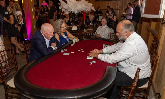 Two people seated at a blackjack table 