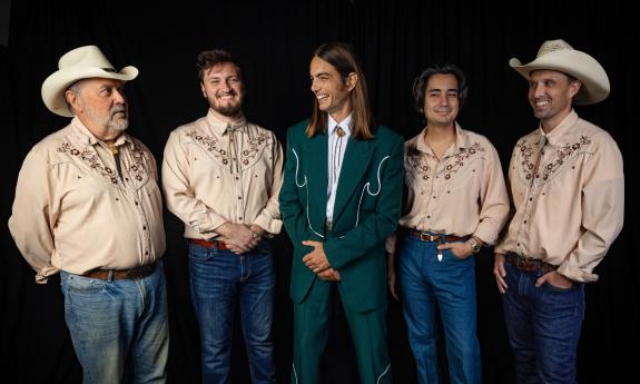 The five members of Brett Staska and the Souvenirs standing in their country music outifits