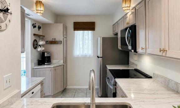 This new kitchen, as seen from the opening to the living room has a coffee station