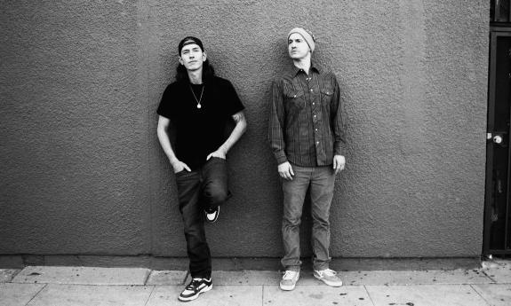 Singers, rappers, musicians DJ Hoppa and Wax in front of a wall