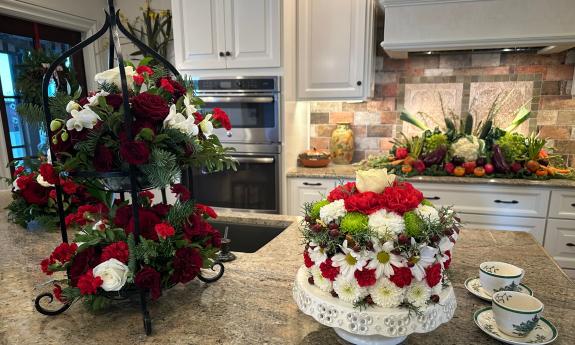 This kitchen features floral displays on the kitchen island