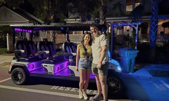 A couple outside the cart at night