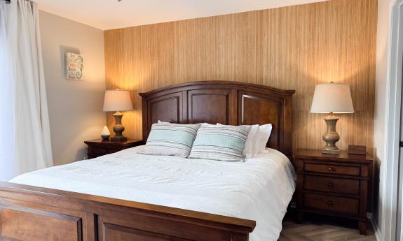 The master bedroom has a king-size bed, and doors to the balcony