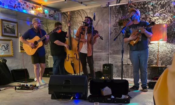 The four member of St. Augustine Bluegrass Unit performing in a small venue