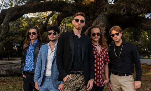 The Fellas, a band from Jacksonville, standing outside under a live oak tree
