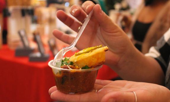 A tasting sample of chili held in the hands of the lucky taster 