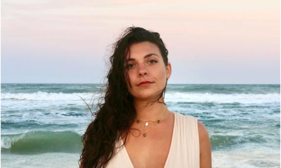 musician Marissa Christine standing with beach behind her