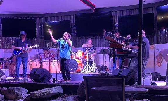 Bandmates from Ultimate Santana performs live on stage.