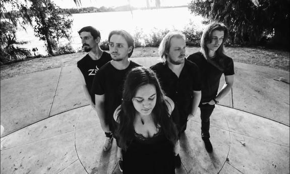 The five members of Black Heart Society outside standing in a V formation