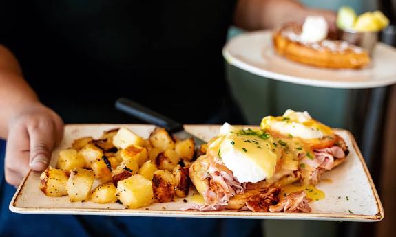 An eggs benedict and potato dish