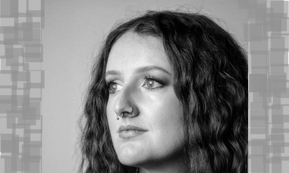 Lauren Woodall, staring to her right against a grey screen