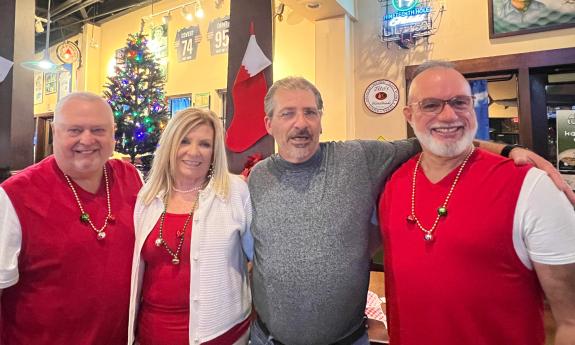 The four members of On Time Vocal Group in a row during a Christmas party