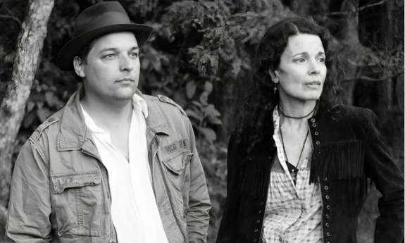 The bandmates of Donna the Buffalo turn their heads in unison, gazing intently at a distant object on the horizon.