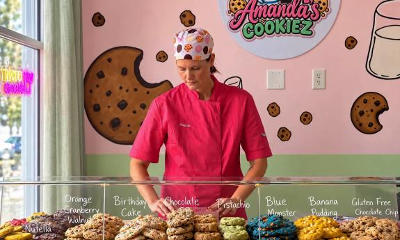 Amanda from Amanda's Cookiez behind the display case