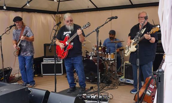 The Mojo Healers performing live on an outdoor stage