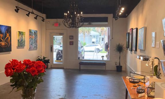 Paintings hanging on the walls inside the gallery
