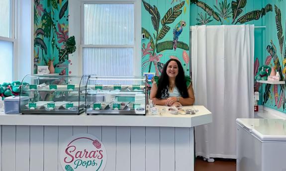 Sara, the owner of the shop, behind the counter