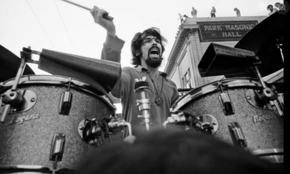The drummer from Shakedown Citi performs in front of an audience.