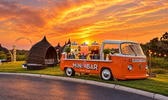The outdoor area with seating and a mini bar truck