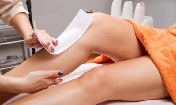Women getting legs waxed 