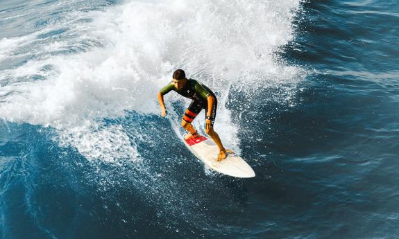 A surfer rides a wave.