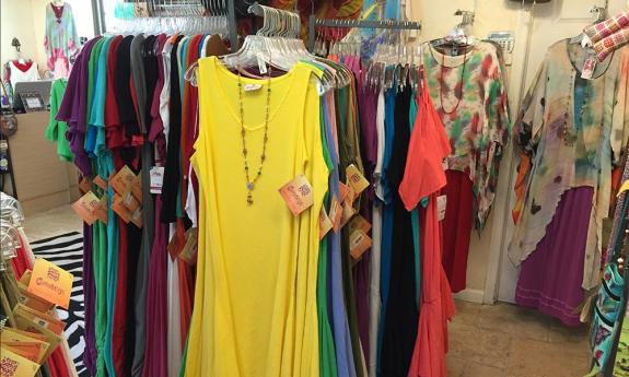 A colorful selection of women's cotton dresses on display