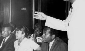 Dr. Robert B. Hayling (standing) airing his grievances to Florida Governor Burns alongside Civil Rights leaders (seated, Left to Right: B.J. Johnson representing Dr. Martin Luther King; Mrs. Loucille Plummer from Saint Augustine; Attorney for CORE John Due) in Tallahassee, 1965. (Image courtesy of Florida Memory)