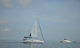 A sailboat and boat we rode by in the ocean.